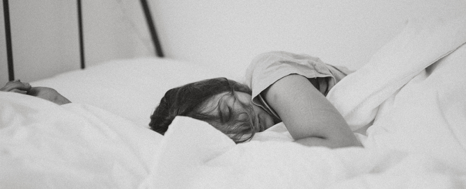 Image of woman sleeping. Photo by Kinga Cichewicz on Unsplash