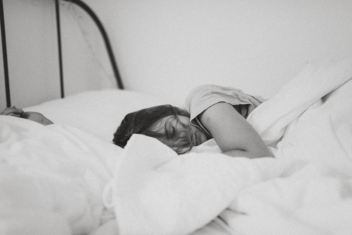Image of woman sleeping. Photo by Kinga Cichewicz on Unsplash