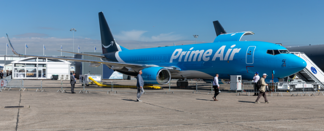 Image of parked Prime Air freight plane with crew