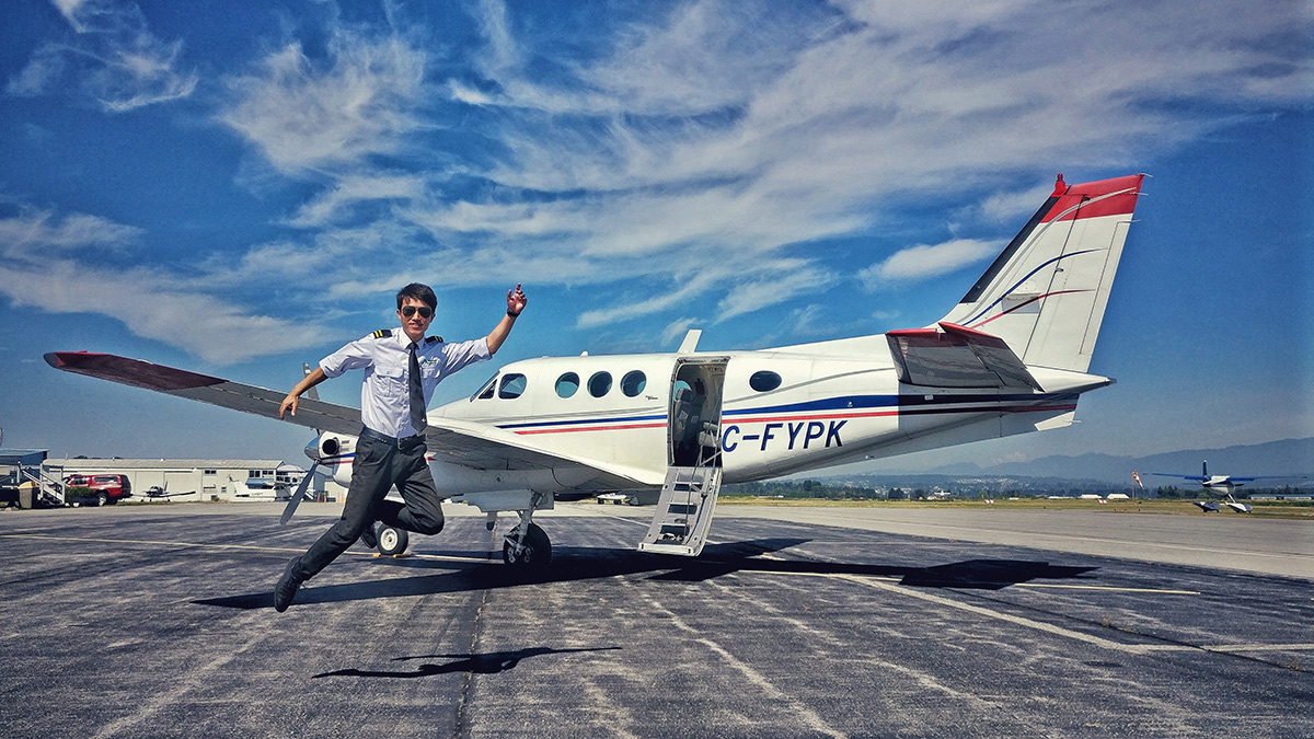 Image of charter pilot leaping into the air with his aircraft in the background.