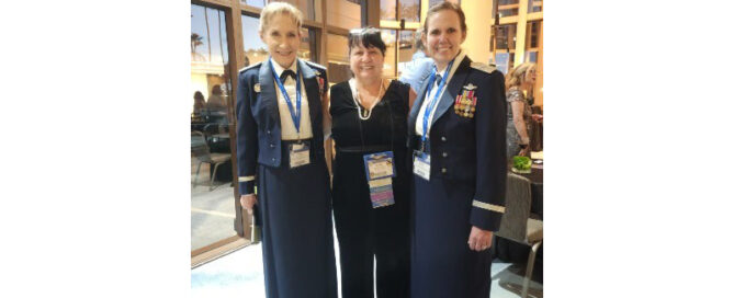 Photo of Colonel Kathy Cosand (Ret) in uniform, Major General Jeannie Leavitt in a suit, at Brigadier General Regina Sabric in uniform together at an event.