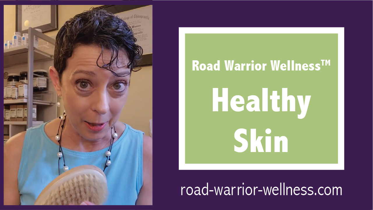 Graphic with Dr. Mary Warren on the left holding a dry brush and a green text box saying Road Warrior Wellness, Healthy Skin on the right over a purple background and above the website road-warrior-wellness.com.